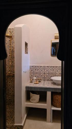a bathroom with a sink and a mirror at Riad Alizé in Marrakesh