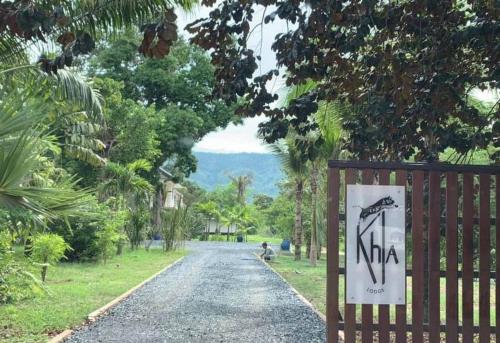 a gate to a road with a sign on it at Khla Lodge in Kampot
