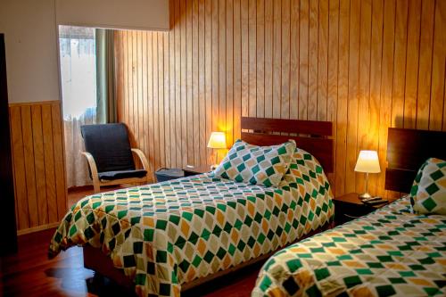 En eller flere senger på et rom på Roble Austral Hostal