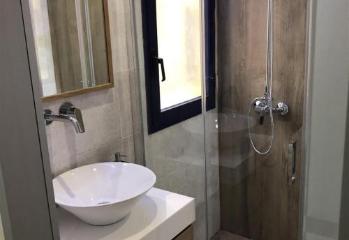 a bathroom with a sink and a glass shower at Bungalow Bahia Meloneras in Maspalomas