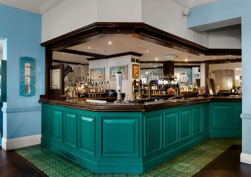 a green bar in a room with a counter at Kingscliff, BW Signature Collection in Clacton-on-Sea