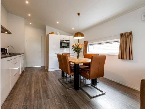 a kitchen and dining room with a table and chairs at Holiday Home Green Resort Mooi Bemelen-1 by Interhome in Bemelen