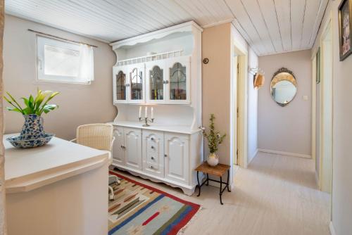 a living room with a white cabinet and a table at Waterfalls in Gaios