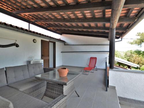 a patio with a couch and a table and chairs at Holiday Home Latin by Interhome in Barban