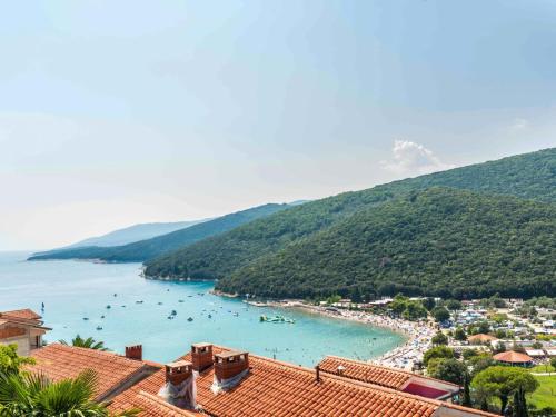 a view of a beach with boats in the water at Apartment Adria - RAC171 by Interhome in Rabac