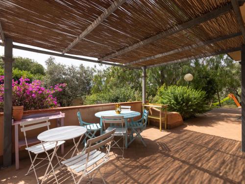 a patio with a table and chairs under a pergola at Holiday Home Villa Trabbia by Interhome in Cisano sul Neva