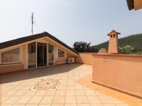 a house with a tile patio and a building at Holiday Home Villa Trabbia by Interhome in Cisano sul Neva