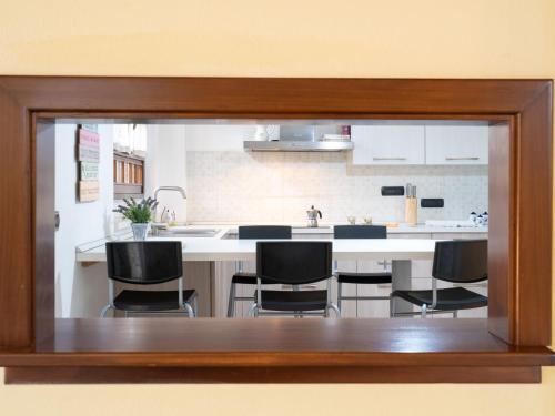 a view of a kitchen through a glass window at Holiday Home Villa Trabbia by Interhome in Cisano sul Neva