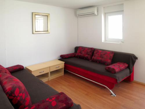 a living room with a couch and a chair at Holiday Home Helena - Pag310 by Interhome in Pag