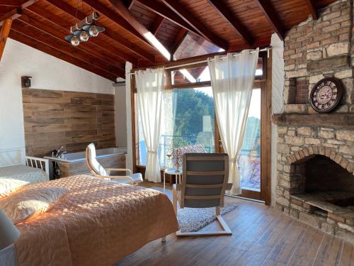 a bedroom with a bed and a stone fireplace at The Stone Castle Boutique Hotel in Ağaçlı