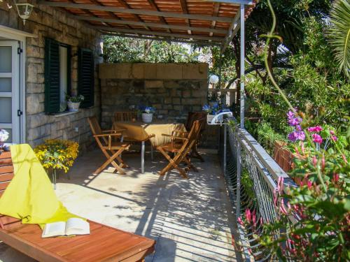 a patio with a table and chairs under a pergola at Holiday Home Garden Apartment - BRC650 by Interhome in Sumartin