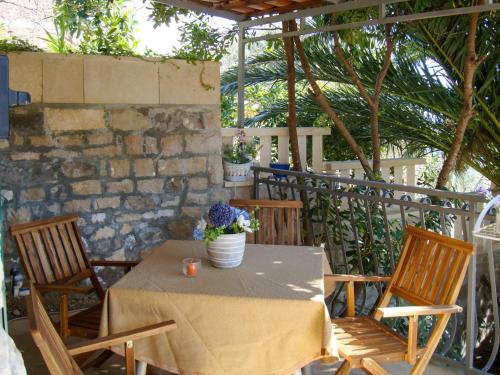 a table and chairs on a patio at Holiday Home Garden Apartment - BRC650 by Interhome in Sumartin