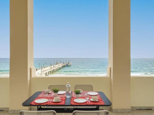 a dining table with a view of the ocean at Apartment Terrazza sul Molo by Interhome in Alassio