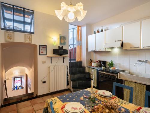 a kitchen and a dining room with a table at Holiday Home Angela - DOL100 by Interhome in Dolcedo