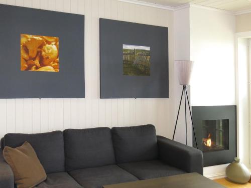 a living room with a couch and a fireplace at Apartment Havsdalshovda - HLD101 by Interhome in Geilo