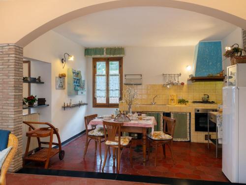 a kitchen with a table and chairs in a room at Apartment Casa del Cavaliere by Interhome in Dolcedo