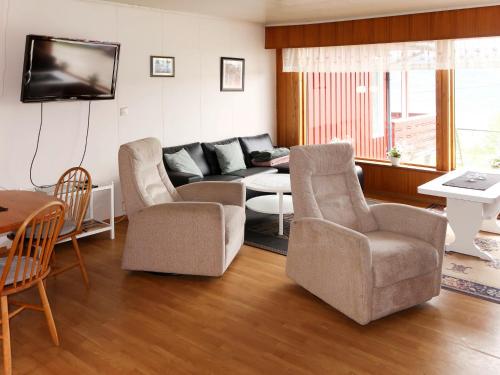 a living room with a couch and chairs and a table at Apartment Mjellhaugen - FJS221 by Interhome in Naustdal i Sunnfjord