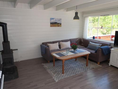 a living room with a couch and a coffee table at Holiday Home Njord by Interhome in Arnefjord