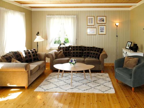 a living room with two couches and a coffee table at Holiday Home Haven - SOO334 by Interhome in Birkeland