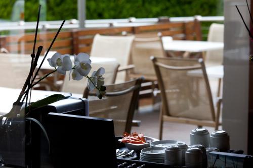 a table with flowers in a vase on top of it at Hotel Rio Bidasoa in Hondarribia