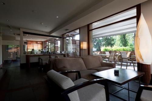 a living room with a couch and a table at Hotel Rio Bidasoa in Hondarribia
