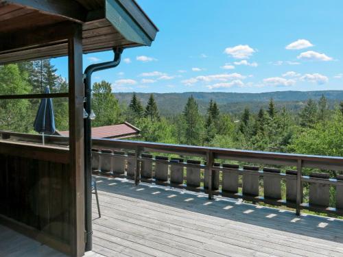 a deck with a view of the mountains at Holiday Home Skafjellstoga by Interhome in Åmli