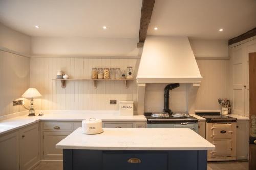 a kitchen with a stove and a counter top at Lanesfoot Farm in Harrogate