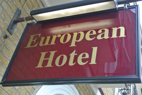 a red and white sign on a building at European Hotel in London