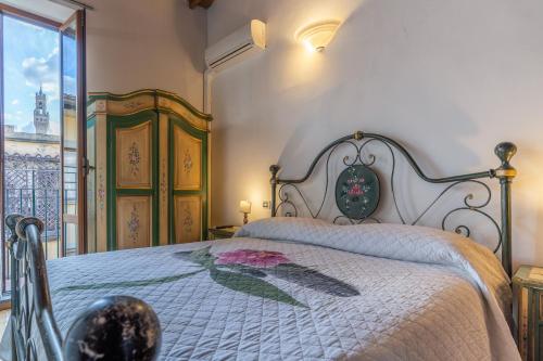 une chambre avec un lit avec une fleur dessus dans l'établissement Firenze Rentals Mini Suite Corso, à Florence
