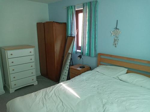 a bedroom with a bed and a dresser at Swn Y Gwy ~ The Sound of the Wye in Brecon