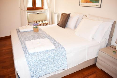 a bedroom with a white bed with a table at VG [VIA DEL CORSO 5 STELLE] Luxury apartment in Rome