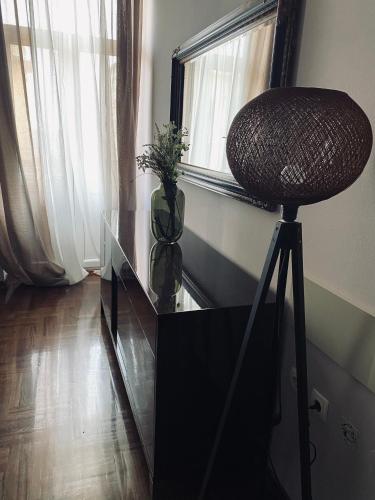 a chair sitting on a glass table next to a window at Apartment Abbazia in Opatija