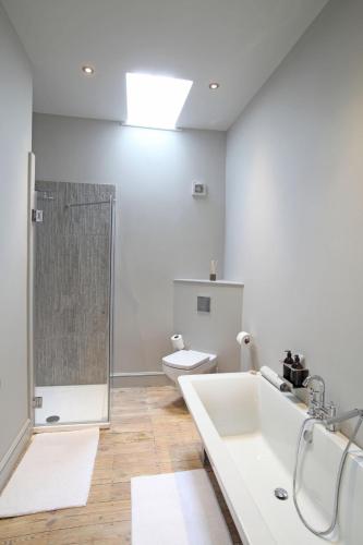 a bathroom with a shower and a sink and a toilet at No33 HUNSTANTON BOUTIQUE ROOMS in Hunstanton