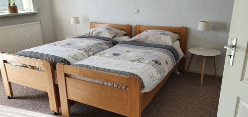 two bunk beds in a room with a table at Vakantiehuis de wilgenhof in Wetering
