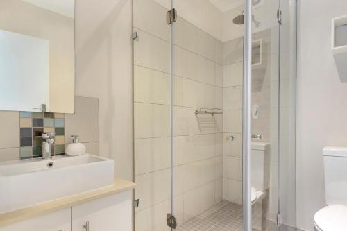 a bathroom with a shower and a sink at Urban Oasis at Apex in Johannesburg