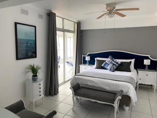 a bedroom with a king sized bed and a chair at 71 Kyalanga in Durban