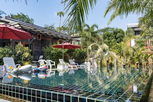 a swimming pool with a water park with inflatables at The Loft Panwa Resort in Panwa Beach