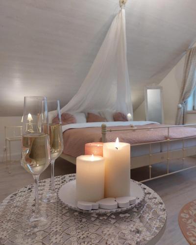 a table with candles and wine glasses in a bedroom at Boutique hotel Soukeníkův dům in Kutná Hora