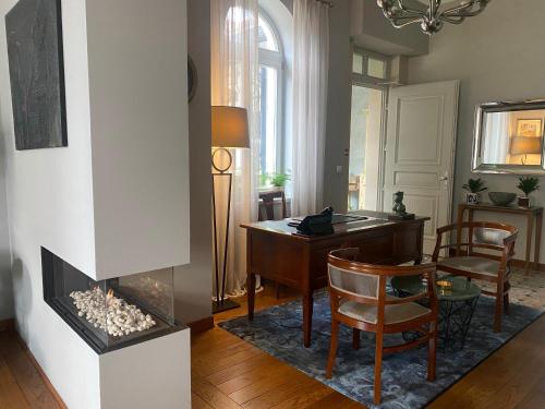 a living room with a desk and a fireplace at Villa Promenade in Burgas City