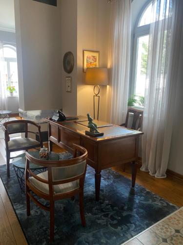 a living room with a wooden table and chairs at Villa Promenade in Burgas City