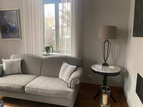 a living room with a couch and a table at Villa Promenade in Burgas City