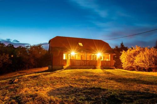 a house with lights on the front of it at Bakina iža in Duga Resa