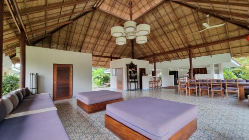 a room with two beds and a table and chairs at Khla Lodge in Kampot