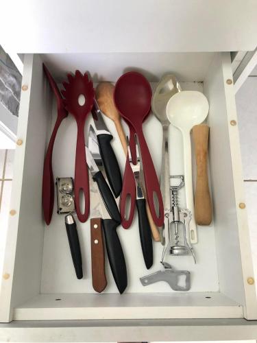 a drawer filled with lots of cooking utensils at Aloha Vibes Ap Cumbuco - Green Club in Cumbuco
