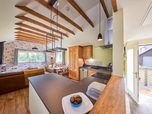 a large kitchen with wooden floors and wooden ceilings at Forest Farm Cottage in Haywards Heath