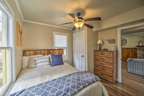 a bedroom with a bed and a ceiling fan at Lakefront Eucha Escape with Views and Boat Slip! in Eucha