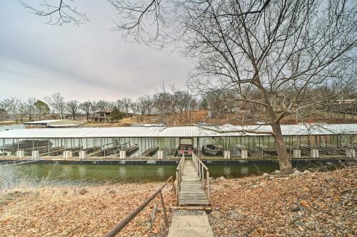 a bridge over a river with a train on it at Lakefront Eucha Escape with Views and Boat Slip! in Eucha