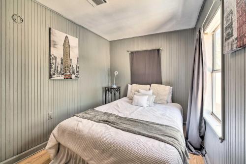 a bedroom with a bed with a picture on the wall at Cozy Livingston House with Fenced Yard and Patio! in Livingston