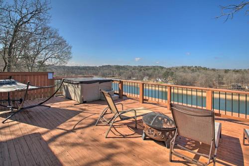 a deck with chairs and a table and a grill at Hot Tub and Views Waterfront Escape in Hot Springs in Hot Springs