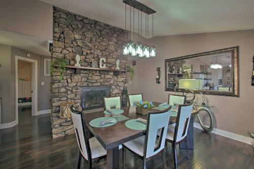 a dining room with a table and a stone wall at Hot Tub and Views Waterfront Escape in Hot Springs in Hot Springs